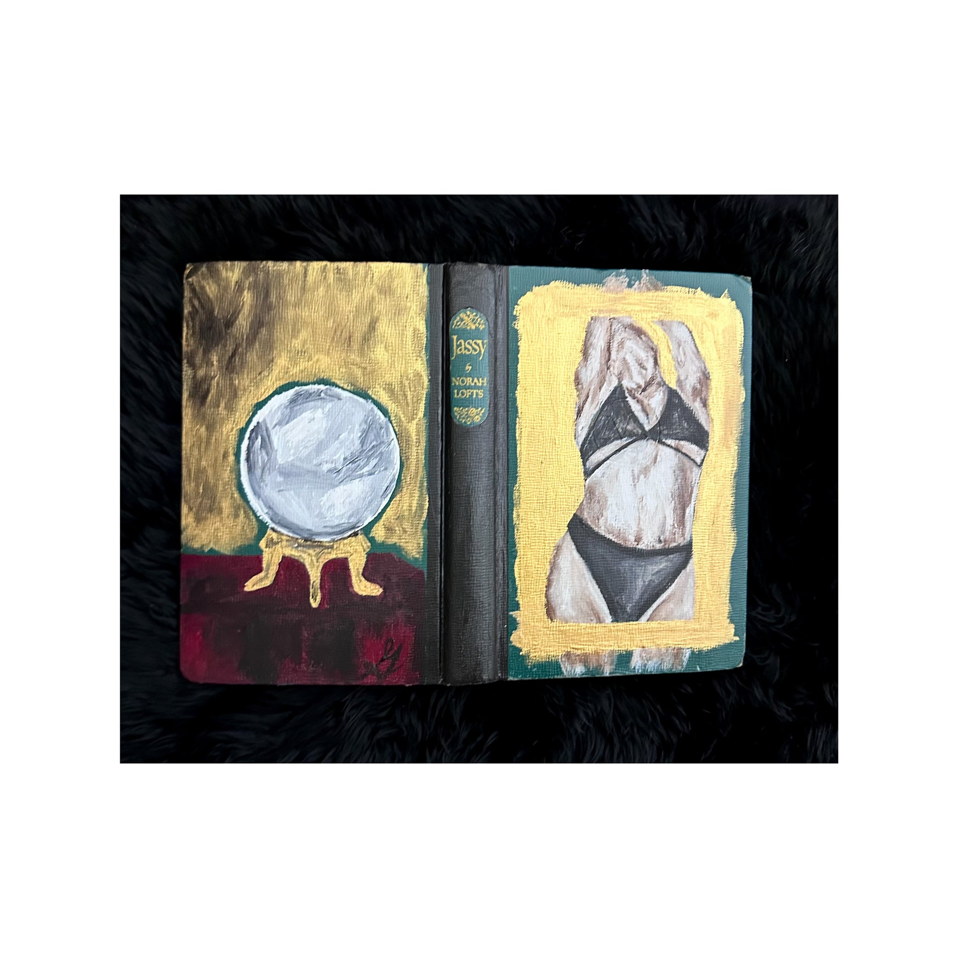 Book with artistic covers featuring a crystal ball and a figure in a bikini.