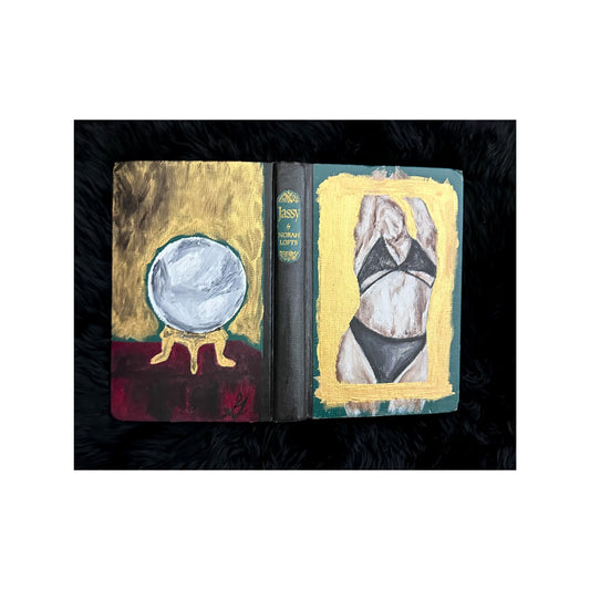 Book with artistic covers featuring a crystal ball and a figure in a bikini.